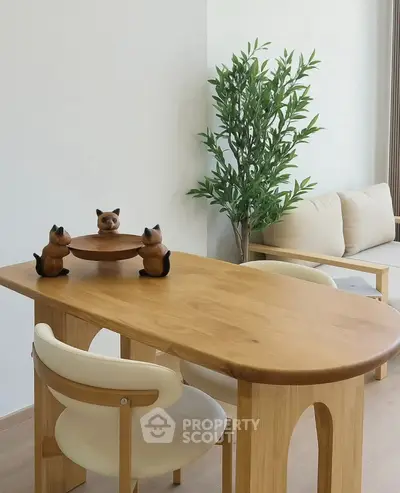 Modern living room with wooden table, chairs, and decorative plant