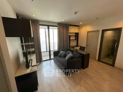 Modern living room with sleek furniture and balcony access in a stylish apartment.