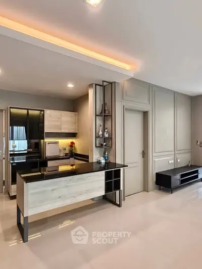 Modern kitchen with sleek black countertops and open layout in stylish apartment.