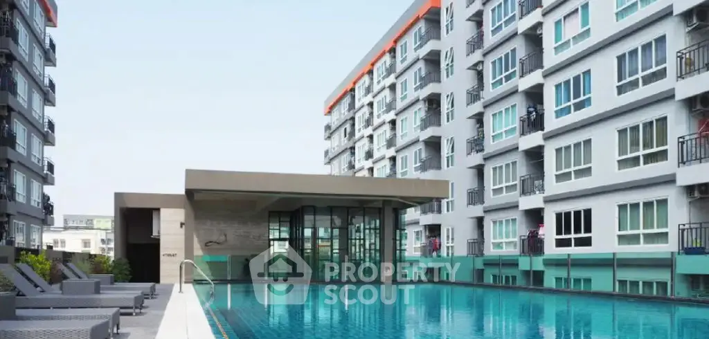 Modern apartment complex with a luxurious swimming pool and stylish architecture.
