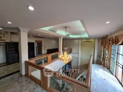 Luxurious two-story living room with elegant chandelier and marble flooring