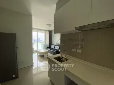 Modern kitchen with open layout and city view in a high-rise apartment