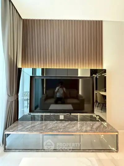 Luxurious modern living room with sleek TV setup and elegant decor