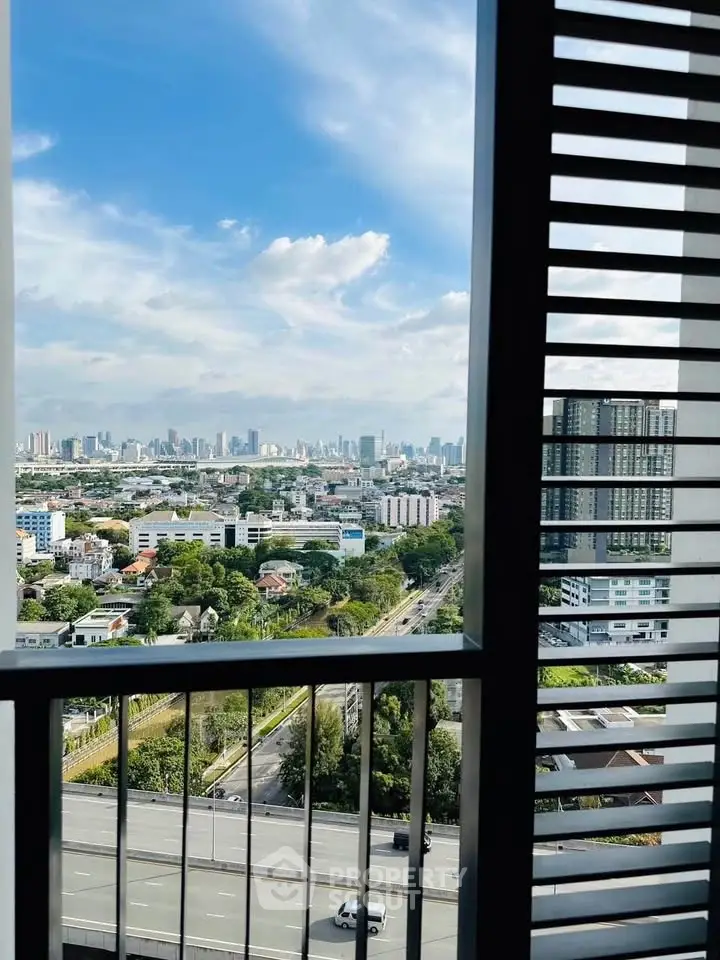 Stunning cityscape view from a modern high-rise balcony, showcasing urban skyline and lush greenery.