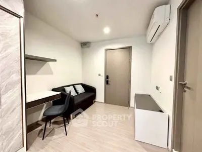 Modern minimalist living room with sleek furniture and air conditioning.