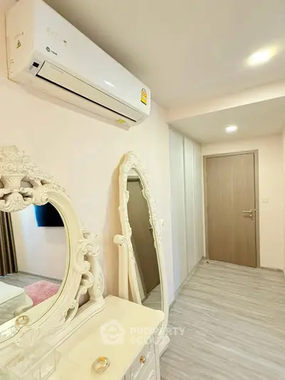 Elegant bedroom with ornate mirror and air conditioning unit