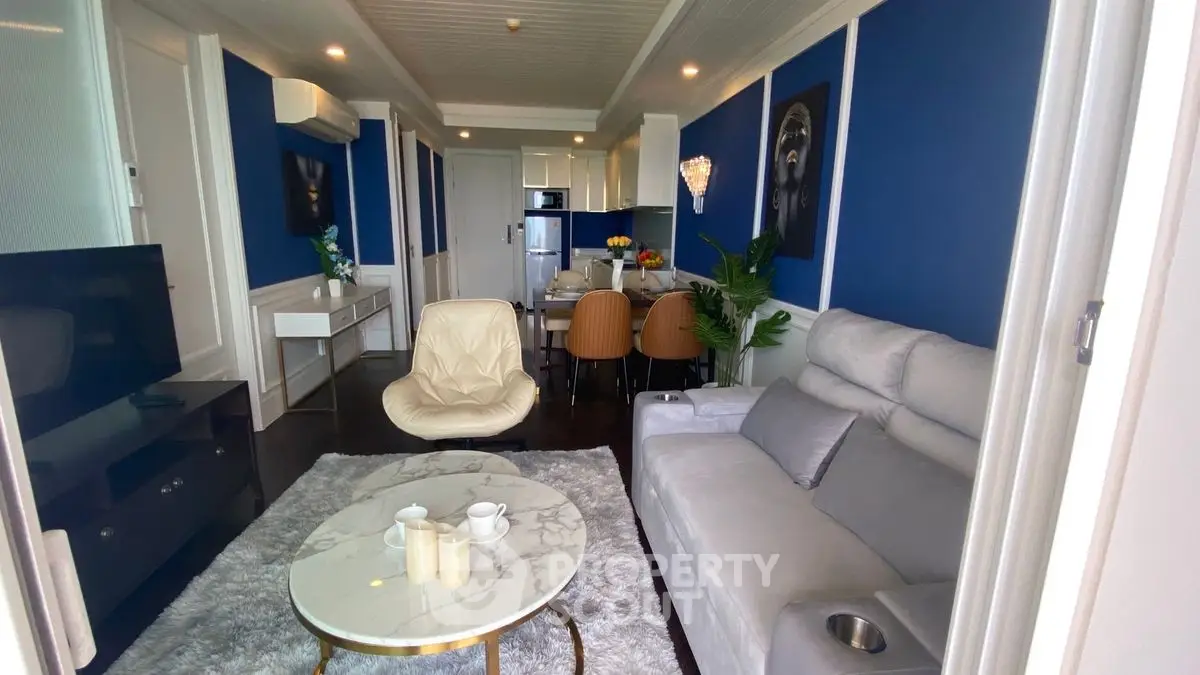 Luxurious living room with modern decor and elegant dining area in open layout apartment.