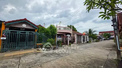 Charming residential street with diverse architectural styles and lush greenery, perfect for family living.