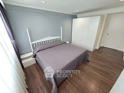 Spacious bedroom with modern decor and ample natural light