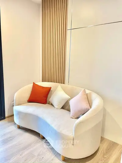 Stylish modern living room with elegant curved sofa and decorative pillows