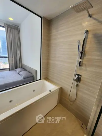 Modern bathroom with bathtub and shower, adjacent to bedroom with city view.