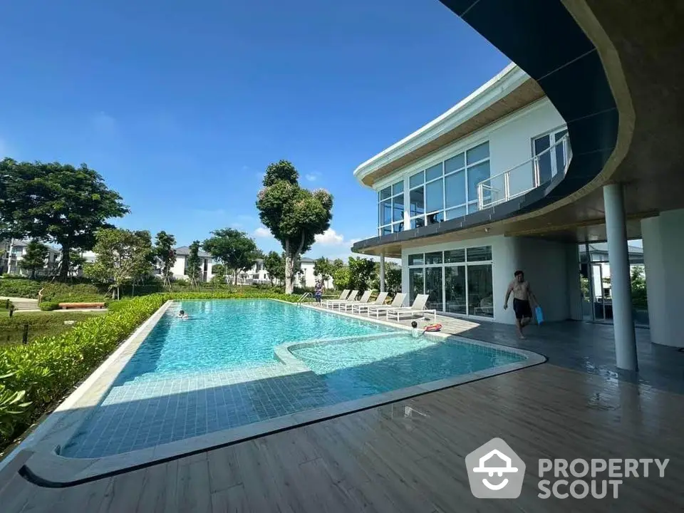 Luxurious modern villa with stunning pool and lush garden, perfect for relaxation and entertainment.