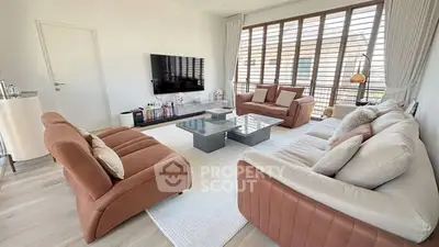 Spacious modern living room with elegant furniture and large windows