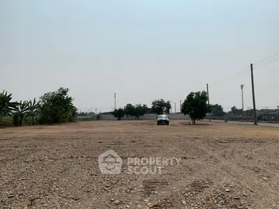 Expansive vacant land with potential for development, featuring open space and clear skies.