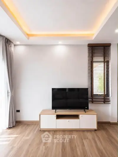 Modern living room with sleek TV stand and elegant lighting