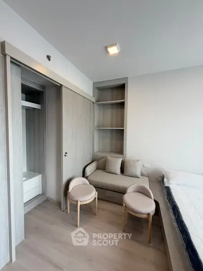 Modern bedroom with built-in closet and cozy seating area