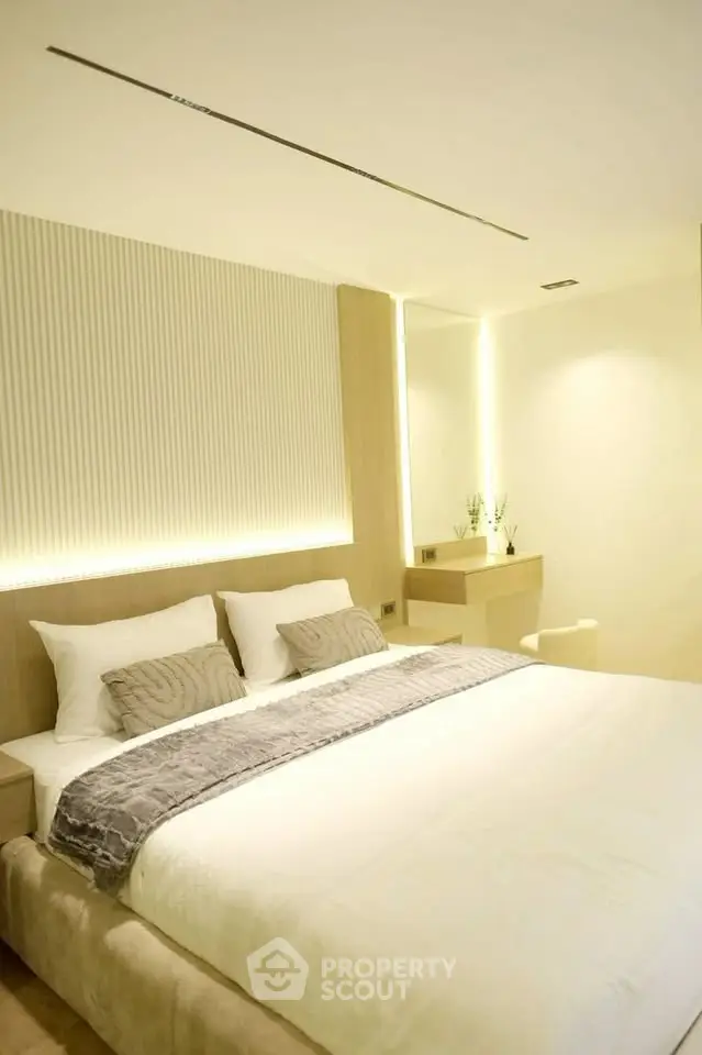Luxurious modern bedroom with elegant lighting and plush bedding