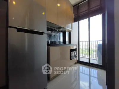 Modern kitchen with sleek cabinets and balcony view