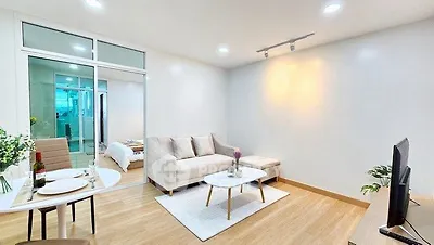 Modern living room with cozy seating and elegant decor in a stylish apartment.