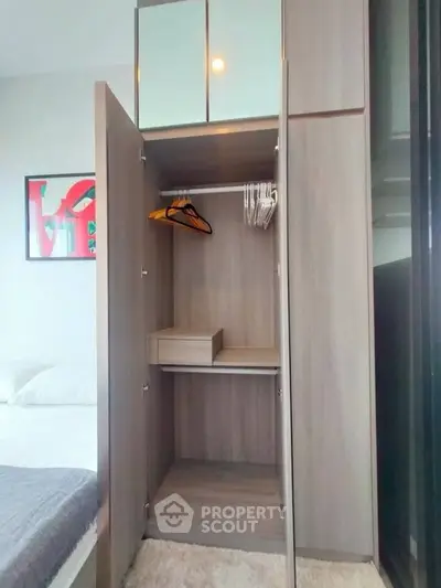 Modern bedroom with open wardrobe and stylish decor