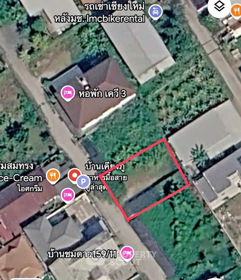 Aerial view of residential area with marked plot of land for sale in urban setting.