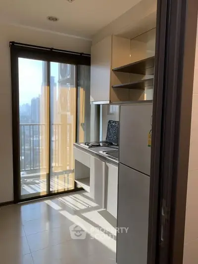 Modern kitchen with balcony view and sleek appliances