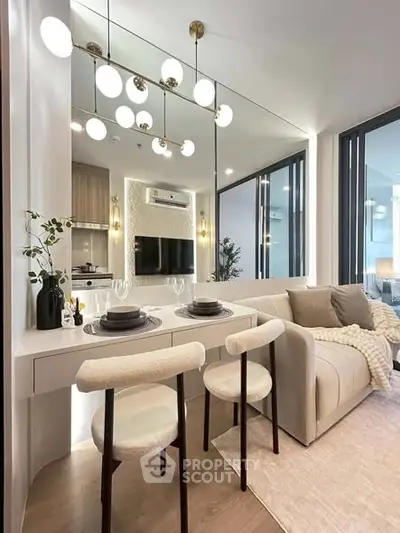 Modern living room with elegant dining area and stylish lighting in a cozy apartment.
