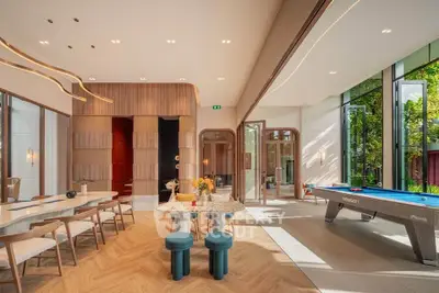 Luxurious open-plan living space with pool table and modern dining area.