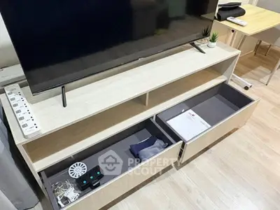 Modern living room with sleek TV stand and organized storage drawers, perfect for stylish urban living.