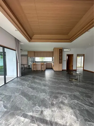 Spacious modern living room with open kitchen and elegant marble flooring
