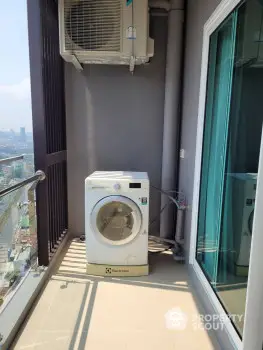 High-rise balcony with washing machine and city view