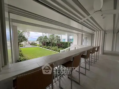 Luxurious open-air balcony with stunning garden view and modern seating area.