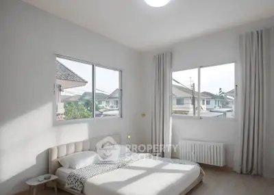 Bright and airy bedroom with large windows and modern decor in a suburban home.
