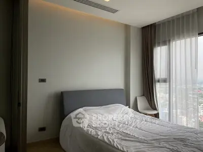 Modern bedroom with large window and city view, featuring a cozy bed and minimalist decor.