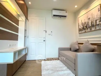 Modern living room with sleek design, featuring a cozy sofa, stylish wall art, and efficient air conditioning.