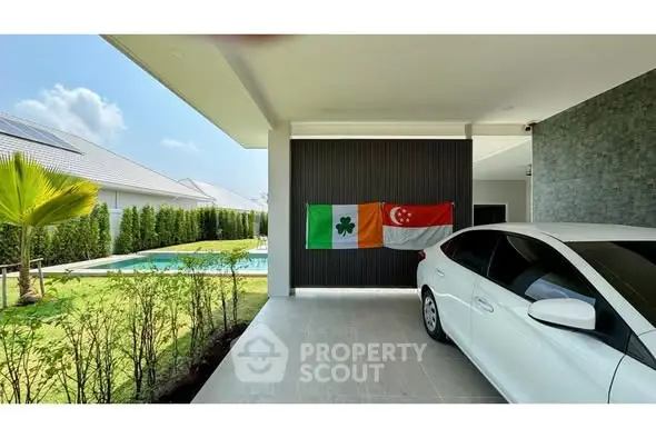 Modern carport with pool view and lush garden in luxury home