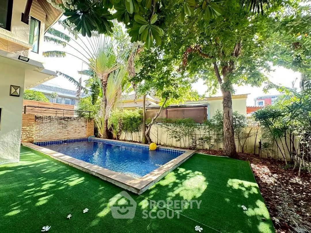 Charming backyard with lush greenery and private pool, perfect for relaxation and outdoor enjoyment.