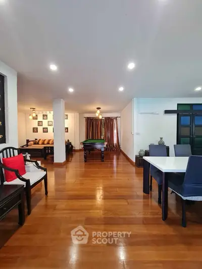 Spacious living room with elegant wooden flooring and modern decor