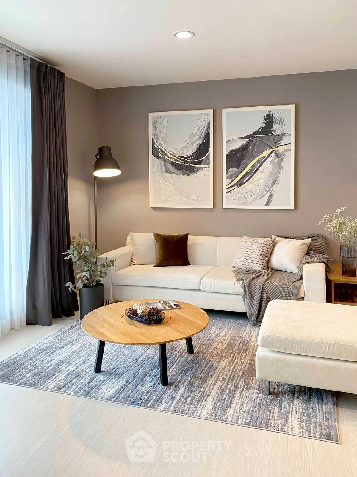 Elegant living room with modern decor, featuring a cozy sofa, stylish coffee table, and contemporary artwork.