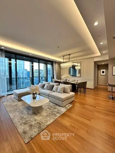 Luxurious modern living room with city view, elegant decor, and spacious layout.