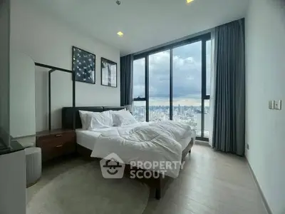 Spacious bedroom with stunning city view and modern decor