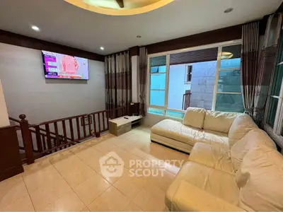 Spacious living room with modern decor and large windows for natural light.