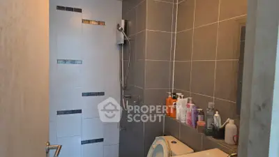 Modern bathroom with sleek gray tiles and shower area