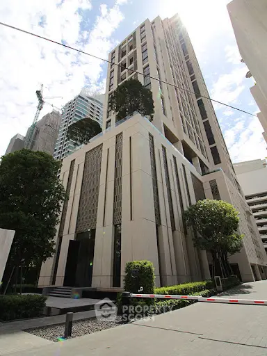 Modern high-rise building with lush greenery and sleek architecture