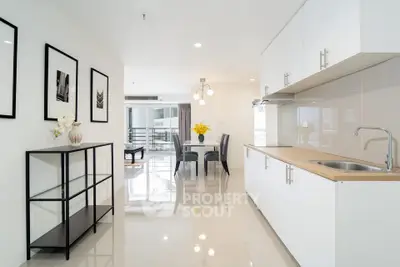 Modern kitchen with sleek white cabinets and open layout, perfect for contemporary living.