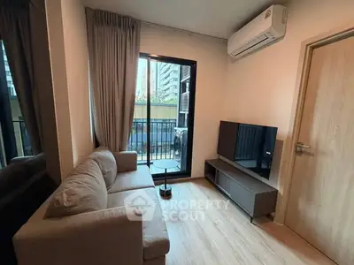 Modern living room with balcony access and air conditioning in urban apartment.