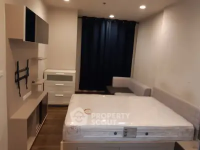 Cozy bedroom with modern furniture and ample storage space in a stylish apartment.