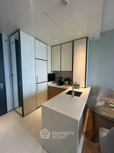 Modern kitchen with sleek cabinetry and island in a contemporary apartment