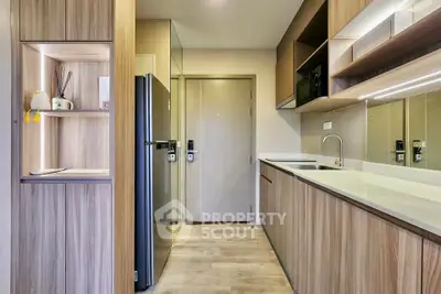 Modern kitchen with sleek cabinetry and integrated appliances in a stylish apartment.
