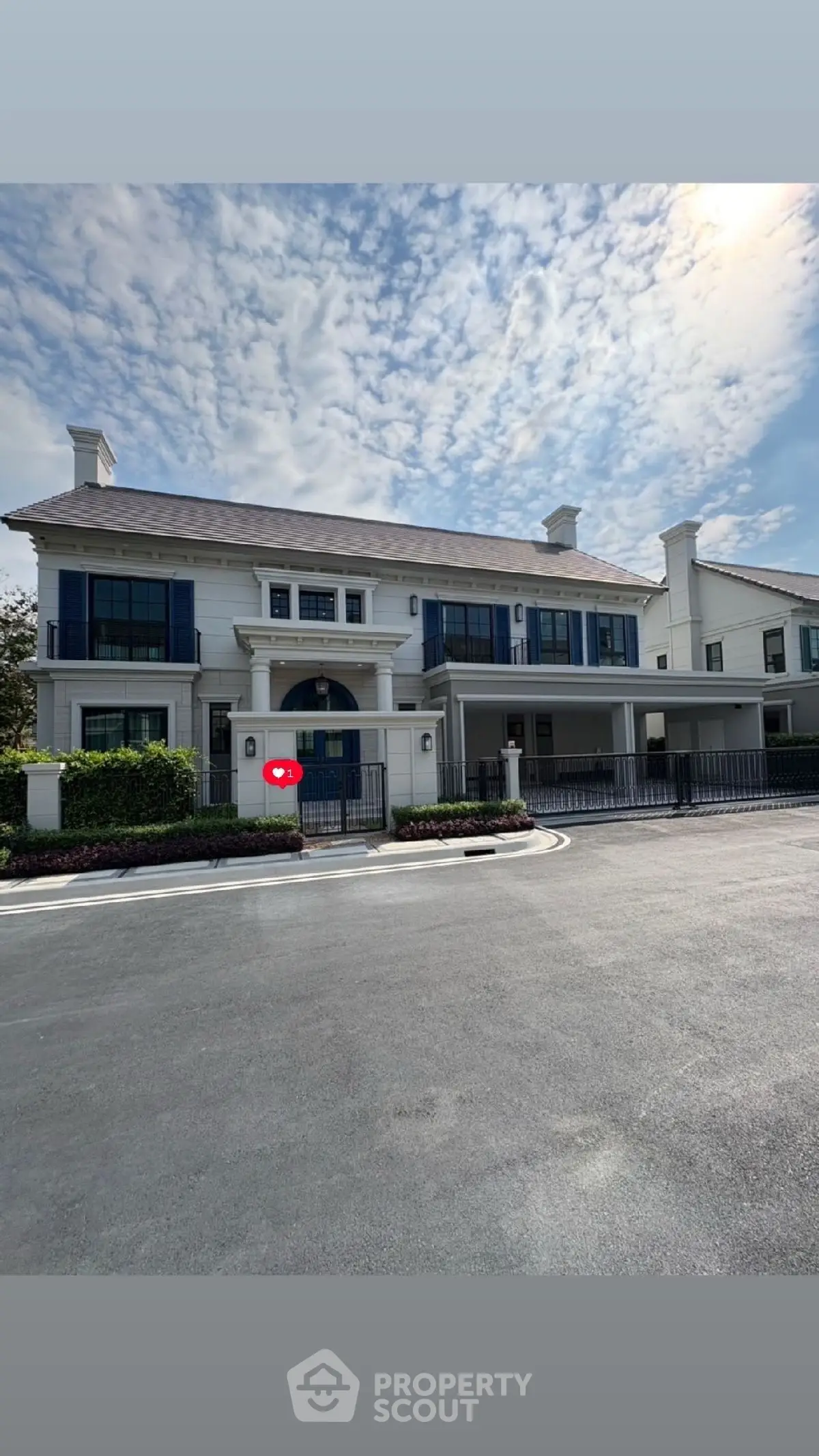 Stunning luxury mansion with elegant facade and spacious driveway under a beautiful sky.